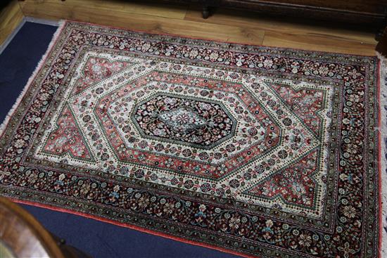 A mathched pair of Qum silk rugs, 5ft 4in by 3ft 4in.